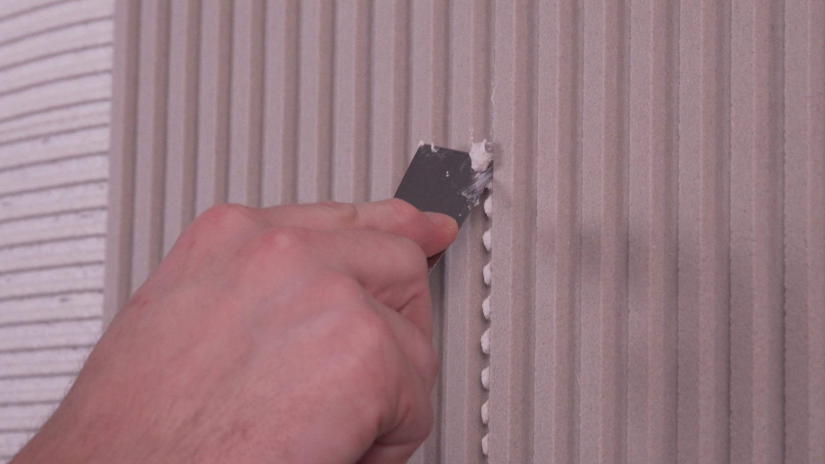Slide each subsequent panel up against the previous one, allowing the adhesive to naturally fill the joints.